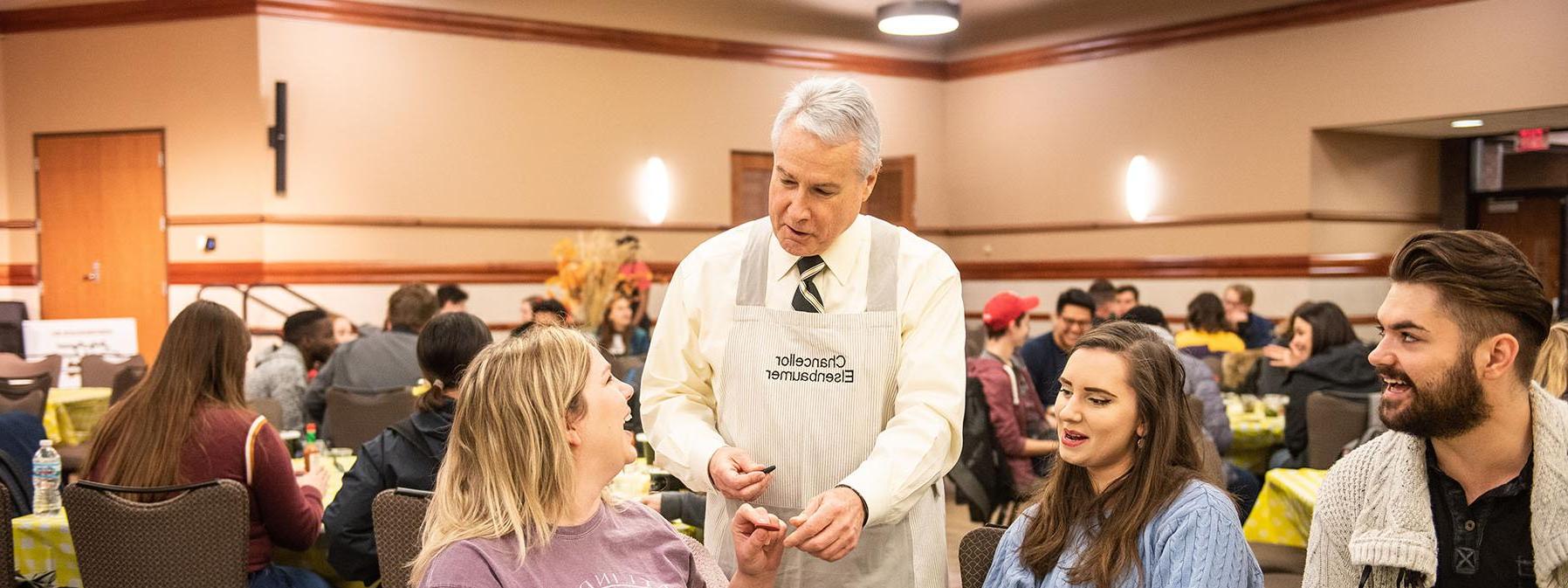 Chancellor Ron Elsenbaumer visits a table at Chili Fest.